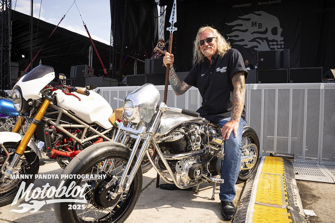 MOTOBLOT 2025 Valhalla winner Rick Dozer seated on his entry, a 1937 Harley-Davidson Flathead, poses will the Gungnir–Odin’s Spear trophy.